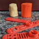 A cylinder of cookie dough next to a cylinder of bright orange Play-Doh